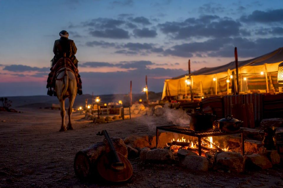 Bedouin camp with camel and BBQ at sunset
