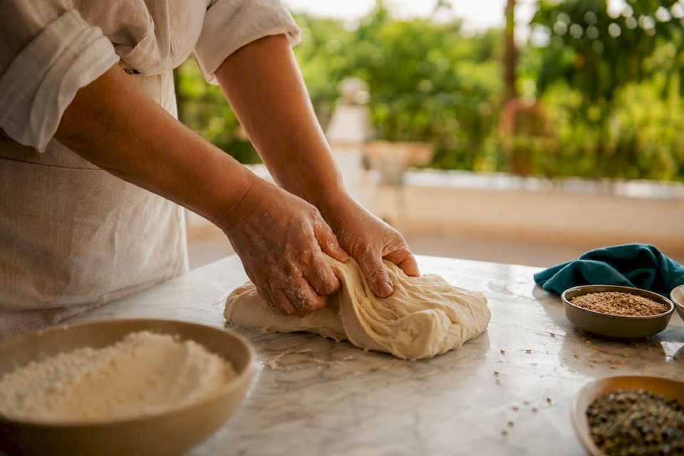 Hands kneading dough for Egyptian bread