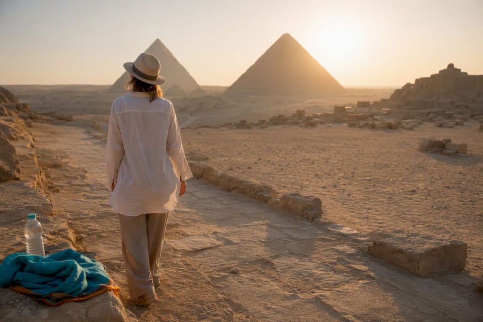 Travelers visiting Giza pyramids at sunrise